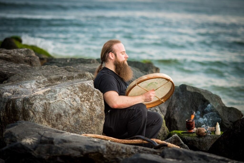 Portrait of Chris Kaplan drumming at the ocean by Jules Wagner, Feather + Root Photography